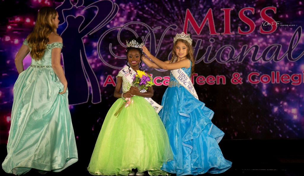 Young contestant smiling as she is crowned on the MNATC stage